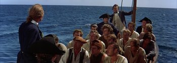 Movie still from “Mutiny on the Bounty” (1962), directed by George Seaton – A group of people in pirate costumes on a boat; Wide shot, High angle