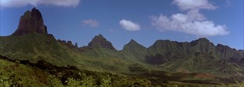 Movie still from “Mutiny on the Bounty” (1962), directed by George Seaton – A view of a mountain range from the side of a hill; Extreme Wide shot, Low angle