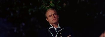 Movie still from “Mutiny on the Bounty” (1962), directed by George Seaton – A person wearing a suit and tie; Close Up shot, Low angle