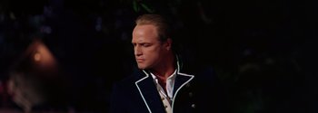 Movie still from “Mutiny on the Bounty” (1962), directed by George Seaton – A man in a black jacket and a white shirt; Close Up shot, Low angle