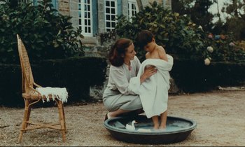 Movie still from “My American Uncle” (1980), directed by Alain Resnais – A woman and a child in a bath tub outside; Medium shot, High angle