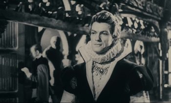 Movie still from “My American Uncle” (1980), directed by Alain Resnais – A black and white photo of a man wearing a suit; Close Up shot, Over the shoulder angle