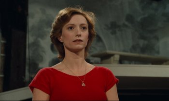 Movie still from “My American Uncle” (1980), directed by Alain Resnais – A woman in a red dress is looking at the camera; Close Up shot, Low angle