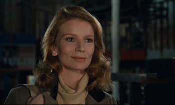 Movie still from “My American Uncle” (1980), directed by Alain Resnais – A woman with long blonde hair wearing a brown jacket; Close Up shot, Low angle