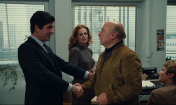 Movie still from “My American Uncle” (1980), directed by Alain Resnais – Two men and a woman shaking hands in an office; Medium shot, Over the shoulder angle