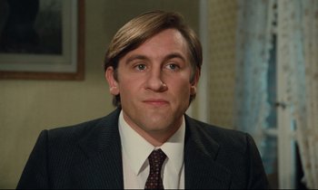 Movie still from “My American Uncle” (1980), directed by Alain Resnais – A person wearing a suit and tie; Close Up shot, Low angle