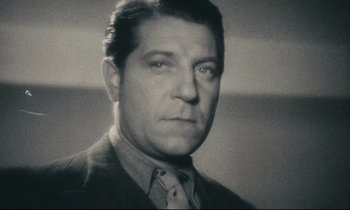 Movie still from “My American Uncle” (1980), directed by Alain Resnais – An older man wearing a suit and a tie; Close Up shot, Low angle