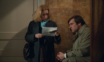 Movie still from “My American Uncle” (1980), directed by Alain Resnais – A woman and a man are looking at a piece of paper; Medium shot, Over the shoulder angle