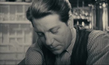 Movie still from “My American Uncle” (1980), directed by Alain Resnais – A black and white photo of a man in a suit and tie; Close Up shot, Low angle