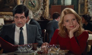 Movie still from “My American Uncle” (1980), directed by Alain Resnais – A man and a woman sitting at a dinner table; Medium shot, Over the shoulder angle