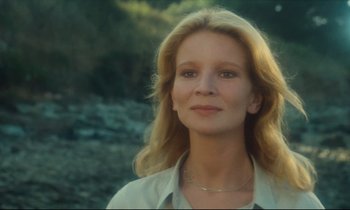 Movie still from “My American Uncle” (1980), directed by Alain Resnais – A woman with long blonde hair wearing a white shirt; Close Up shot, Low angle