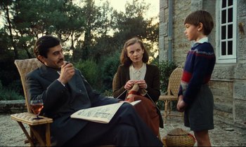 Movie still from “My American Uncle” (1980), directed by Alain Resnais – A group of people sitting on a porch together; Medium shot, Over the shoulder angle