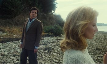 Movie still from “My American Uncle” (1980), directed by Alain Resnais – A man and a woman standing on a rocky beach; Medium shot, Low angle