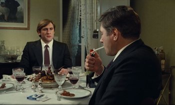 Movie still from “My American Uncle” (1980), directed by Alain Resnais – Two men sitting at a dinner table smoking a cigarette; Medium shot, High angle