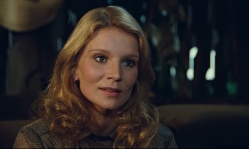 Movie still from “My American Uncle” (1980), directed by Alain Resnais – A person with long blonde hair; Close Up shot, Over the shoulder angle