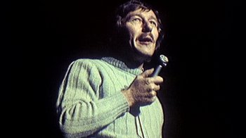Movie still from “My Best Fiend” (1999), directed by Werner Herzog – A man holding a microphone in his hand; Close Up shot, Low angle