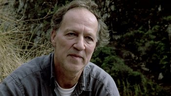 Movie still from “My Best Fiend” (1999), directed by Werner Herzog – A person wearing a gray shirt; Close Up shot, Low angle