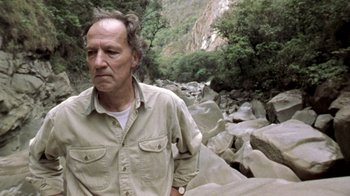 Movie still from “My Best Fiend” (1999), directed by Werner Herzog – An older man standing in the middle of a rocky area; Close Up shot, Low angle