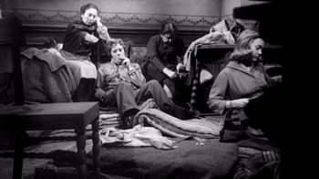Movie still from “My Best Fiend” (1999), directed by Werner Herzog – A group of people sitting on the ground; Wide shot, High angle