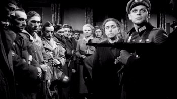 Movie still from “My Best Fiend” (1999), directed by Werner Herzog – A group of people standing in front of a wall; Medium shot, Low angle