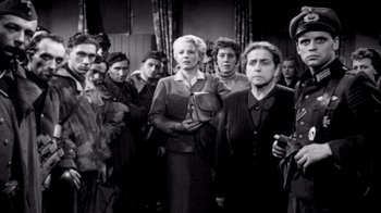 Movie still from “My Best Fiend” (1999), directed by Werner Herzog – A black and white photo of a group of people; Medium shot, Low angle