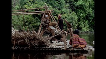 Movie still from “My Best Fiend” (1999), directed by Werner Herzog – A group of people on a raft in the water; Extreme Wide shot, High angle