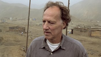 Movie still from “My Best Fiend” (1999), directed by Werner Herzog – An older man in a gray shirt is standing outside; Close Up shot, Low angle