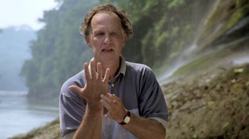 Movie still from “My Best Fiend” (1999), directed by Werner Herzog – A man clapping his hands while standing in front of a waterfall; Close Up shot, Low angle