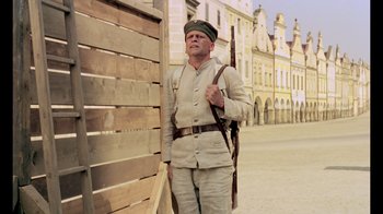 Movie still from “My Best Fiend” (1999), directed by Werner Herzog – A man in a military uniform holding a rifle; Wide shot, Low angle