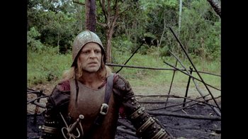 Movie still from “My Best Fiend” (1999), directed by Werner Herzog – A man dressed as a medieval knight poses for a picture; Medium shot, Over the shoulder angle