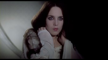 Movie still from “My Best Fiend” (1999), directed by Werner Herzog – A woman with long dark brown hair and a white shirt; Close Up shot, Low angle