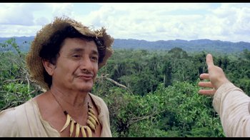 Movie still from “My Best Fiend” (1999), directed by Werner Herzog – A man in a straw hat standing in front of a forest; Close Up shot, Low angle