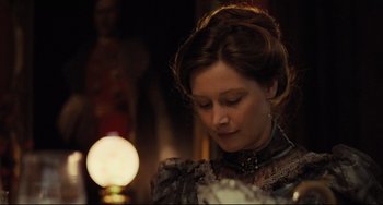 Movie still from “My Brilliant Career” (1979), directed by Gillian Armstrong – A woman in a victorian dress looking down at her face; Close Up shot, Over the shoulder angle