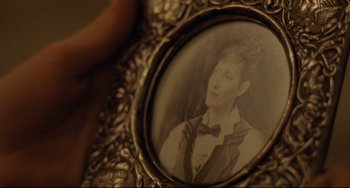 Movie still from “My Brilliant Career” (1979), directed by Gillian Armstrong – An old photo of a woman in a frame; Extreme Close Up shot, Over the shoulder angle