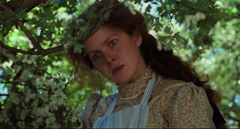 Movie still from “My Brilliant Career” (1979), directed by Gillian Armstrong – A woman in a floral dress standing under a tree; Close Up shot, Low angle