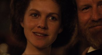 Movie still from “My Brilliant Career” (1979), directed by Gillian Armstrong – A woman's face in a dimly - lit room; Close Up shot, Over the shoulder angle