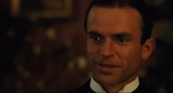 Movie still from “My Brilliant Career” (1979), directed by Gillian Armstrong – A person wearing a suit and tie; Close Up shot, Over the shoulder angle