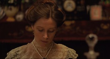 Movie still from “My Brilliant Career” (1979), directed by Gillian Armstrong – A woman in a white dress with a pearl necklace; Close Up shot, Low angle