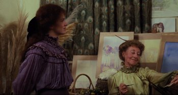 Movie still from “My Brilliant Career” (1979), directed by Gillian Armstrong – Two women dressed in period clothing are standing in front of an easel; Medium shot, Over the shoulder angle