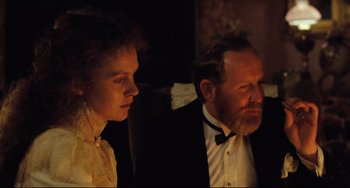 Movie still from “My Brilliant Career” (1979), directed by Gillian Armstrong – A man and a woman in formal wear sitting next to each other; Close Up shot, Over the shoulder angle