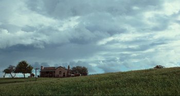 Movie still from “My Brilliant Career” (1979), directed by Gillian Armstrong – A house sitting on top of a green field; Extreme Wide shot, Low angle