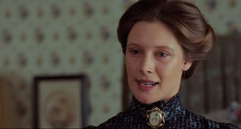 Movie still from “My Brilliant Career” (1979), directed by Gillian Armstrong – A woman with a clock on her neck; Close Up shot, Over the shoulder angle