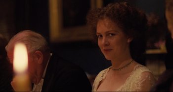 Movie still from “My Brilliant Career” (1979), directed by Gillian Armstrong – A person with curly hair wearing a necklace; Close Up shot, Over the shoulder angle