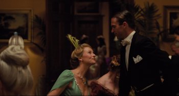 Movie still from “My Brilliant Career” (1979), directed by Gillian Armstrong – A man and a woman dressed up for a party; Medium shot, Low angle