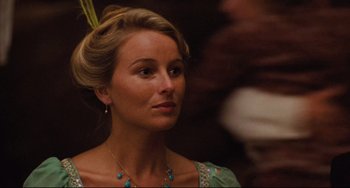 Movie still from “My Brilliant Career” (1979), directed by Gillian Armstrong – A woman with blonde hair wearing a green dress; Close Up shot, Over the shoulder angle