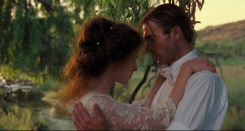 Movie still from “My Brilliant Career” (1979), directed by Gillian Armstrong – A man and a woman embracing each other in a forest; Close Up shot, Low angle