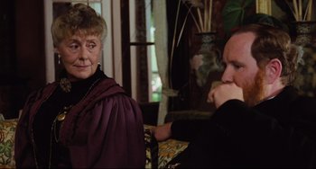 Movie still from “My Brilliant Career” (1979), directed by Gillian Armstrong – A man and a woman sitting in a living room; Close Up shot, Over the shoulder angle