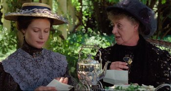 Movie still from “My Brilliant Career” (1979), directed by Gillian Armstrong – Two women sitting at a tea pot on a table; Close Up shot, Low angle