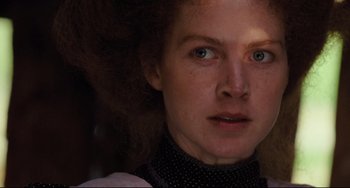 Movie still from “My Brilliant Career” (1979), directed by Gillian Armstrong – A woman's face in a dark room; Close Up shot, Low angle