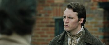Movie still from “My Cousin Rachel” (2017), directed by Roger Michell – A person wearing a suit and tie; Close Up shot, Over the shoulder angle